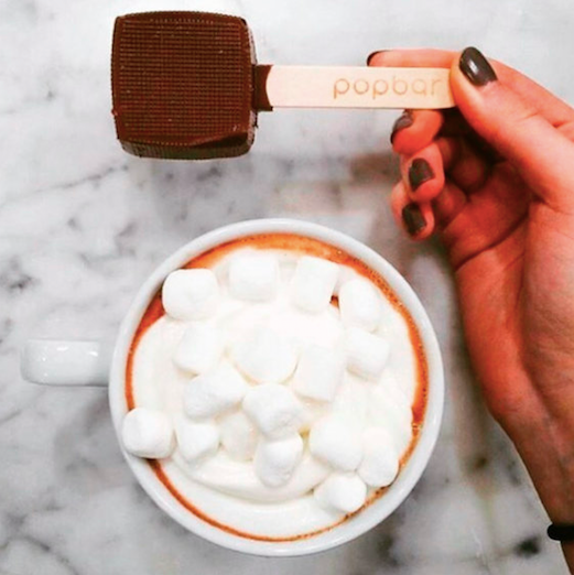 A cup of hot chocolate topped with marshmallow